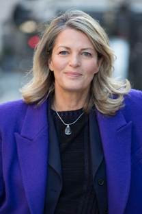 A person in a purple coat
Description automatically generated