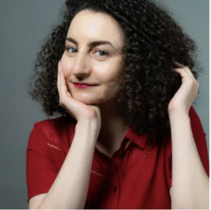 A person with curly hair and red shirt

Description automatically generated